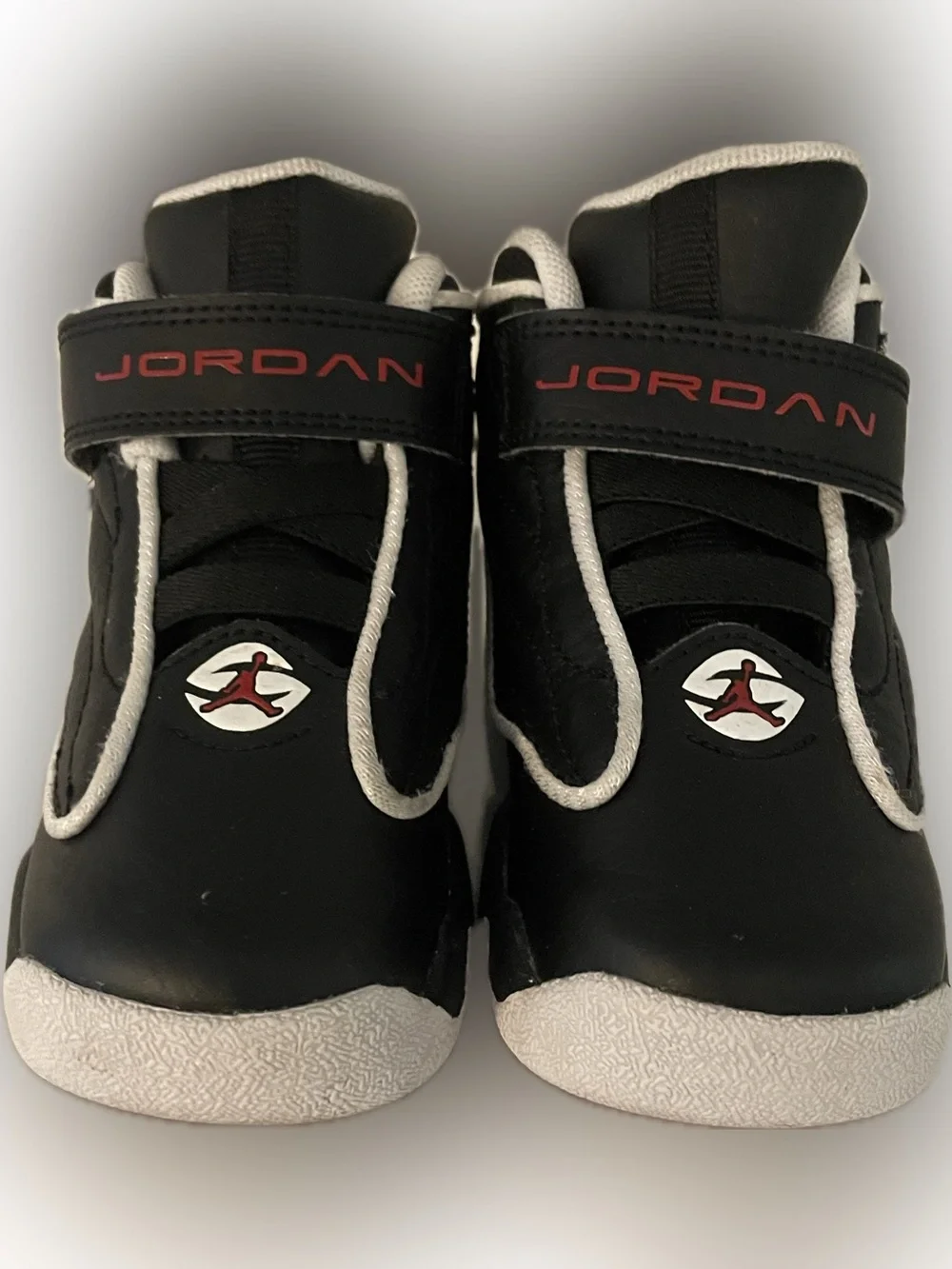 Jordan Black and White Kids Sneakers with Red Logo